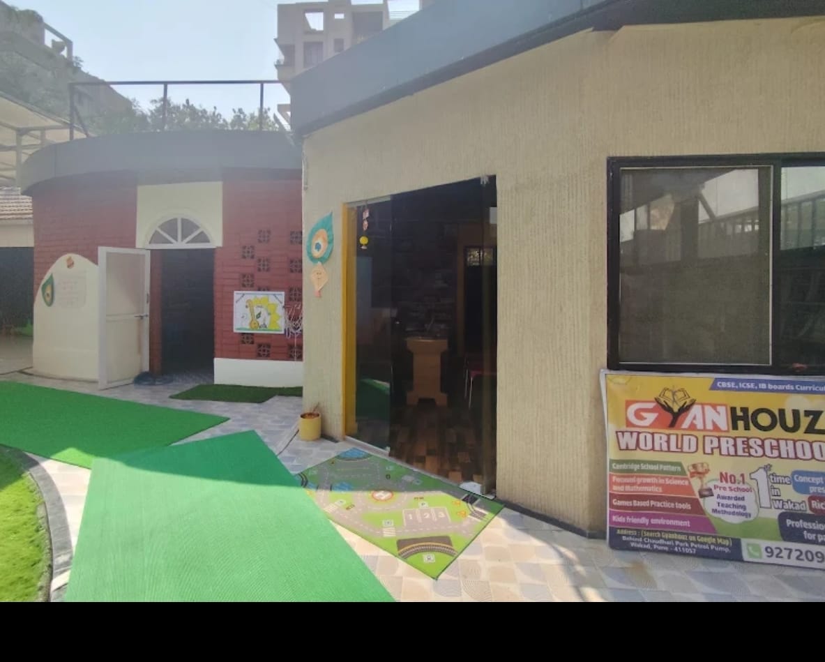 Happy Indian preschool children in colorful classroom actively engaged in hands-on learning activities with teacher